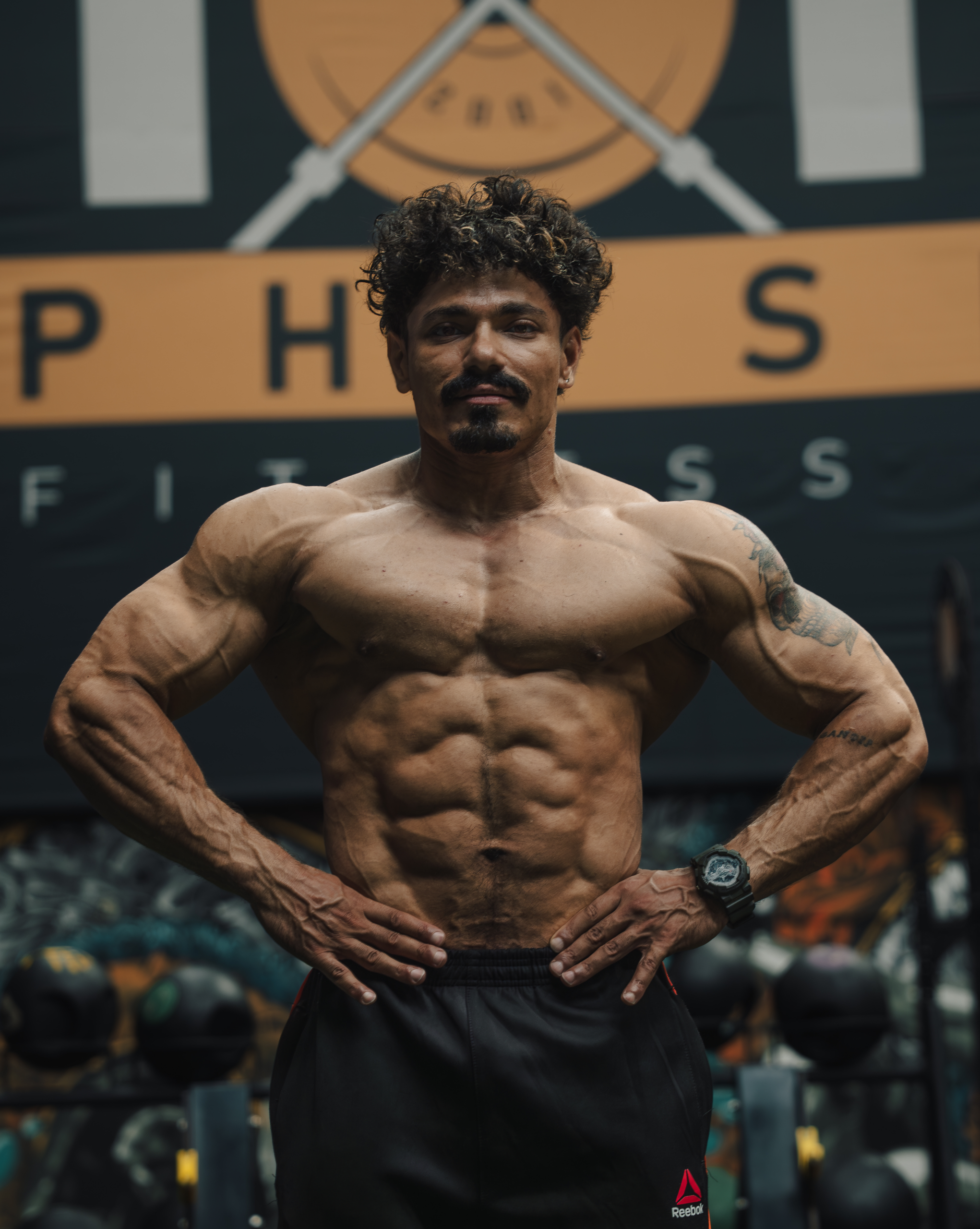 Bodybuilder showcasing muscular physique during a strength training session at Total Physical Fitness Center, highlighting advanced fitness achievements at a leading gym in Baneshwor.
