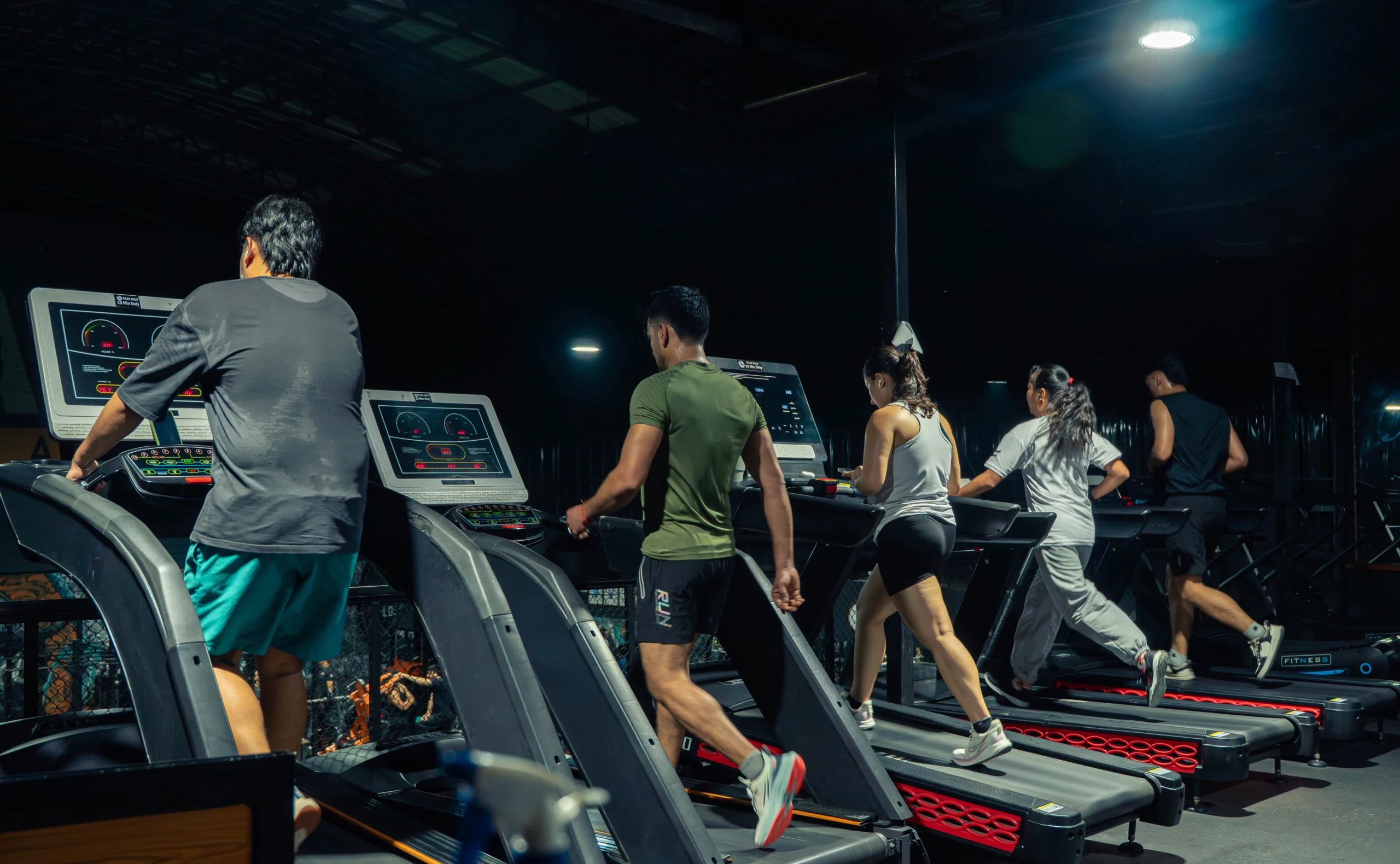 People running on treadmills during a cardio workout session at TPFC gym in Kathmandu.