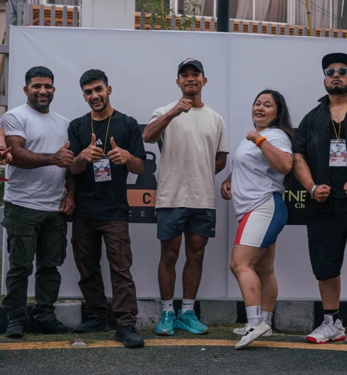 Athlete representing TPFC (Total Physical Fitness Center) competing at the Aisan Powerlifting Championship 2025 during a heavy lift attempt.